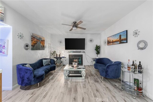 37908 52nd St E, Palmdale, CA 93552 - living room with wood finished floors, ceiling fan, and a glass covered fireplace