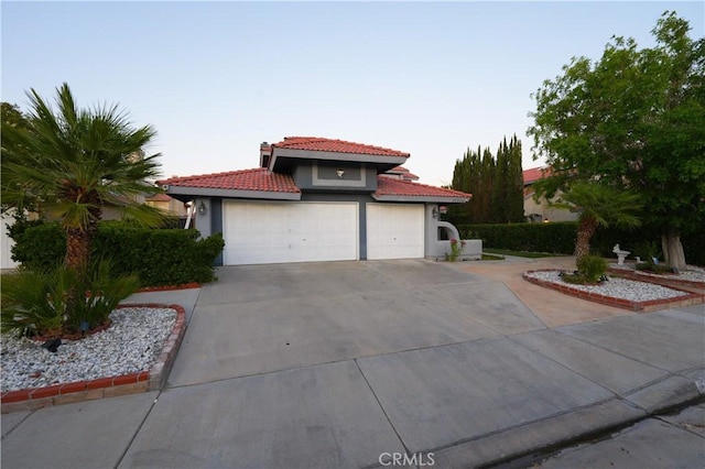 37908 52nd St E, Palmdale, CA 93552 - mediterranean / spanish home featuring a tile roof, stucco siding, driveway, and an attached garage