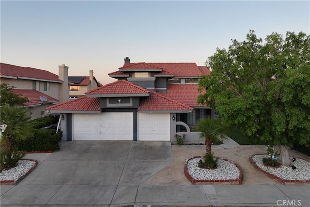 37908 52nd St E, Palmdale, CA 93552 - mediterranean / spanish-style house featuring a tile roof, stucco siding, an attached garage, driveway, and a chimney