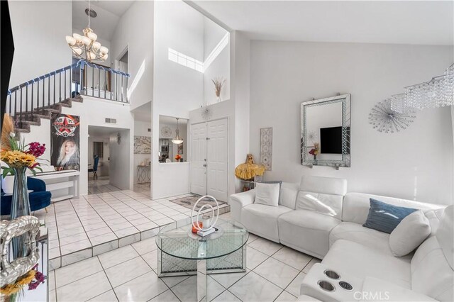 37908 52nd St E, Palmdale, CA 93552 - tiled living room with a chandelier, stairway, and a high ceiling