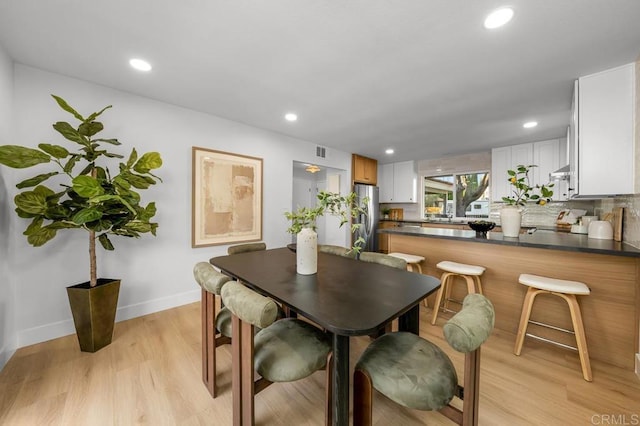 10437 Hermanos Rd, San Diego, CA 92124 - dining room with light wood-style floors and recessed lighting