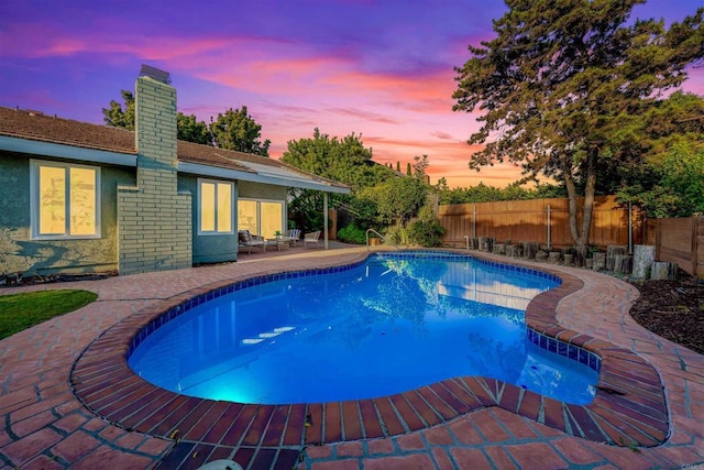 10437 Hermanos Rd, San Diego, CA 92124 - pool at dusk with a fenced backyard and a patio