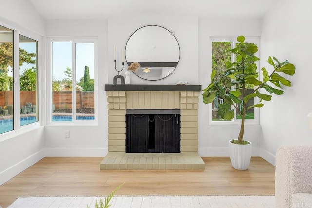 10437 Hermanos Rd, San Diego, CA 92124 - unfurnished living room with plenty of natural light, a fireplace, and wood finished floors