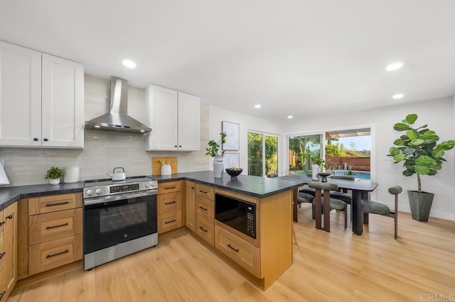 10437 Hermanos Rd, San Diego, CA 92124 - kitchen featuring black microwave, wall chimney exhaust hood, stainless steel electric range oven, light wood-style flooring, and a peninsula
