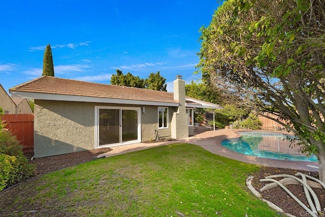 10437 Hermanos Rd, San Diego, CA 92124 - back of property with stucco siding, a fenced backyard, a patio, and a chimney