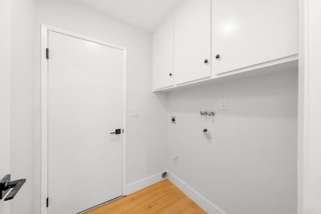 10437 Hermanos Rd, San Diego, CA 92124 - laundry room featuring electric dryer hookup, cabinet space, light wood-style floors, and hookup for a washing machine