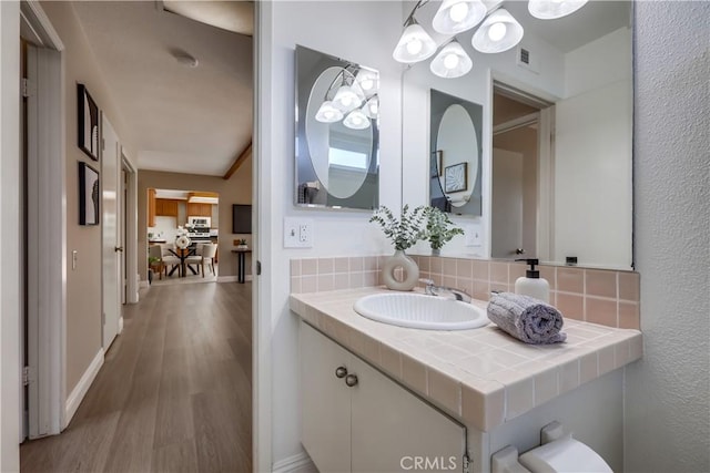 24482 Chrisanta Dr, Mission Viejo, CA 92691 - bathroom featuring tasteful backsplash, wood finished floors, and vanity