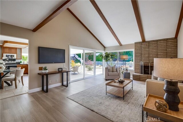 24482 Chrisanta Dr, Mission Viejo, CA 92691 - living room featuring beamed ceiling, high vaulted ceiling, light wood-type flooring, and a fireplace