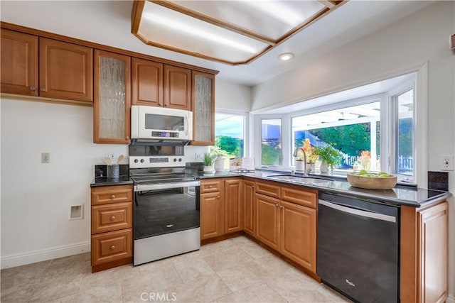 24482 Chrisanta Dr, Mission Viejo, CA 92691 - kitchen with white microwave, dishwasher, stainless steel electric stove, dark countertops, and brown cabinetry