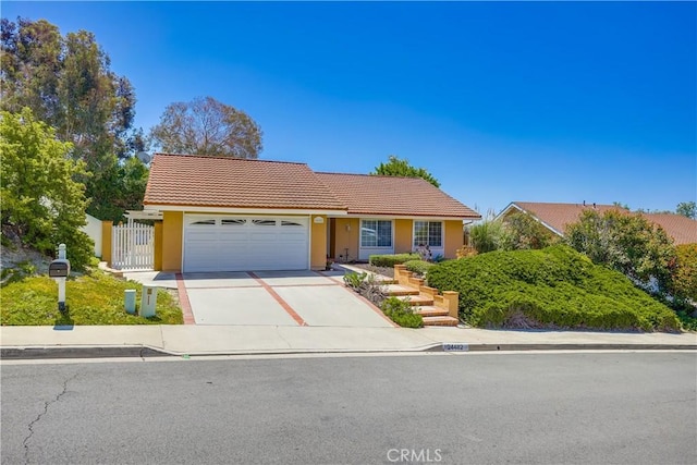 24482 Chrisanta Dr, Mission Viejo, CA 92691 - view of front of home with a tile roof, an attached garage, concrete driveway, and stucco siding