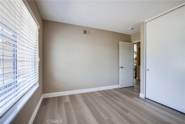 24482 Chrisanta Dr, Mission Viejo, CA 92691 - unfurnished bedroom with multiple windows, light wood-style flooring, and a closet