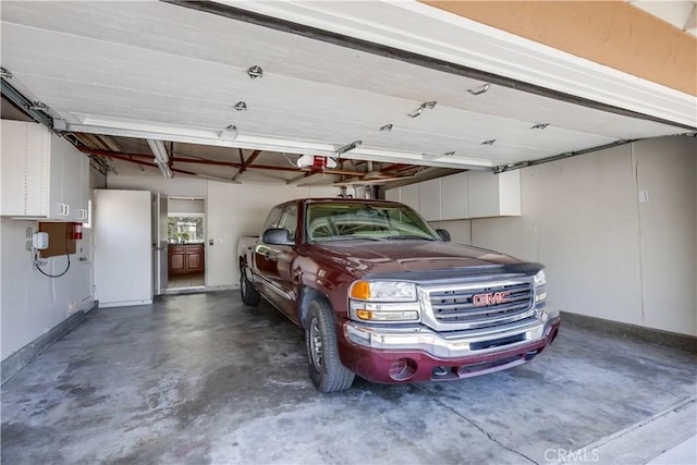 24482 Chrisanta Dr, Mission Viejo, CA 92691 - garage featuring baseboards and a garage door opener
