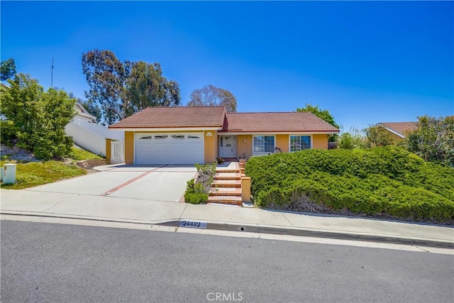24482 Chrisanta Dr, Mission Viejo, CA 92691 - ranch-style house featuring a tile roof, an attached garage, driveway, and stucco siding
