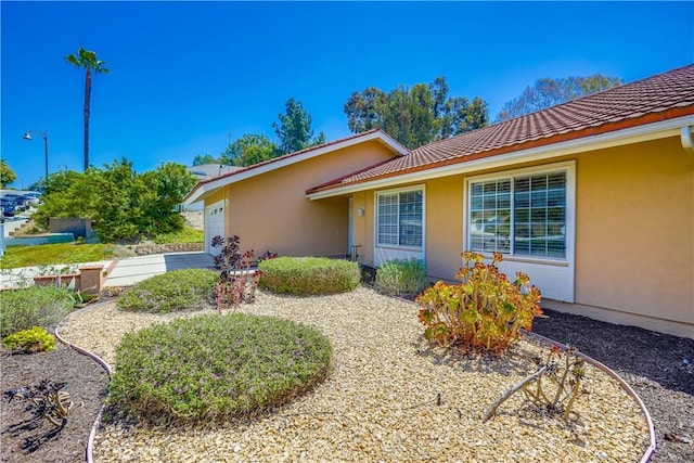 24482 Chrisanta Dr, Mission Viejo, CA 92691 - view of side of property with stucco siding, a garage, and a tiled roof