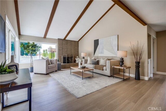 24482 Chrisanta Dr, Mission Viejo, CA 92691 - living area with beam ceiling, light wood-style floors, a fireplace, and high vaulted ceiling