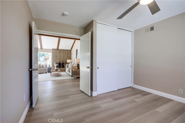 24482 Chrisanta Dr, Mission Viejo, CA 92691 - unfurnished bedroom featuring a fireplace, light wood-type flooring, a closet, and a ceiling fan