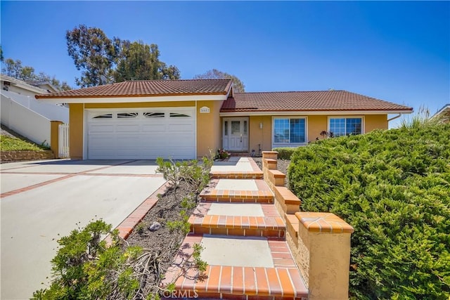 24482 Chrisanta Dr, Mission Viejo, CA 92691 - ranch-style home with a garage, stucco siding, a tile roof, and driveway