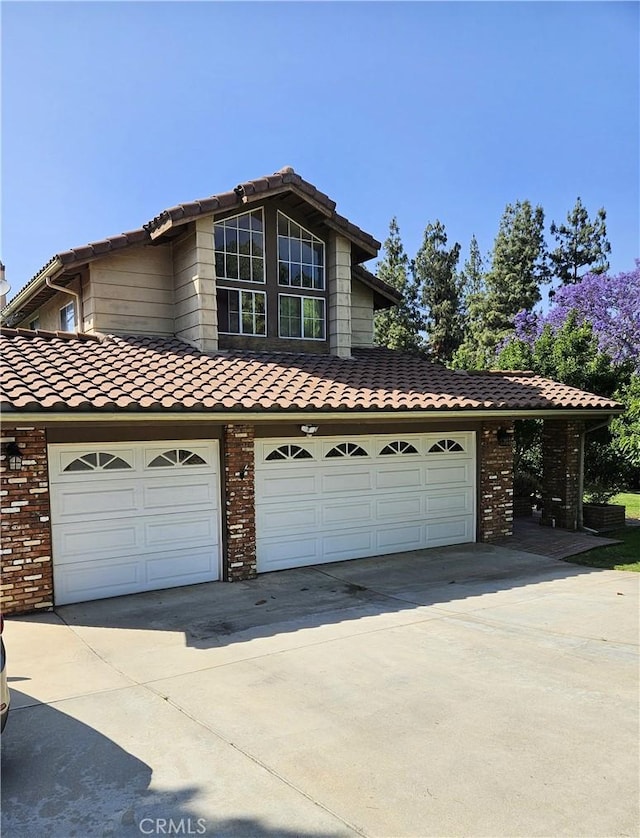 10771 Orchard View Ln, Riverside, CA 92503 - traditional-style home with driveway, a tiled roof, and brick siding