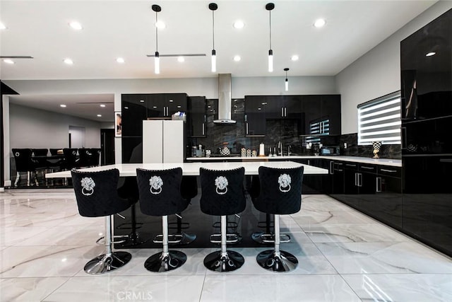 17800 Raymer St, Sherwood Forest, CA 91325 - kitchen featuring wall chimney exhaust hood, dark cabinets, freestanding refrigerator, a large island, and light countertops