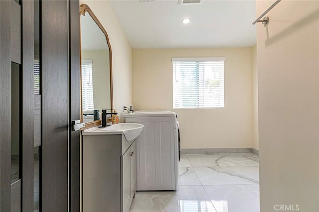 17800 Raymer St, Sherwood Forest, CA 91325 - washroom featuring light marble finish flooring, plenty of natural light, recessed lighting, arched walkways, and washer / clothes dryer