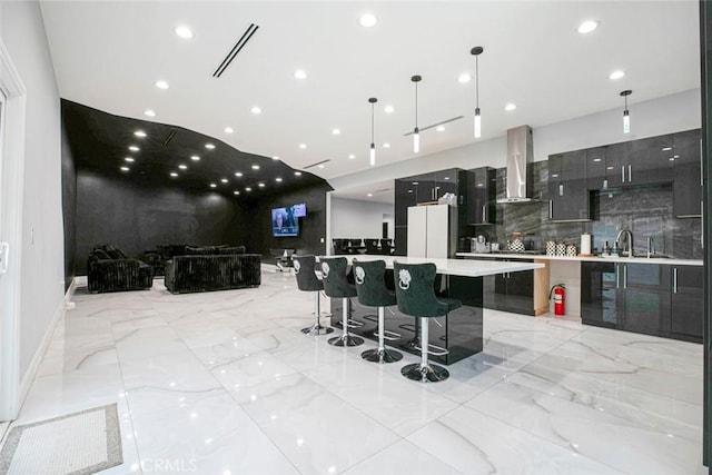 17800 Raymer St, Sherwood Forest, CA 91325 - kitchen featuring wall chimney range hood, modern cabinets, freestanding refrigerator, a large island, and light countertops