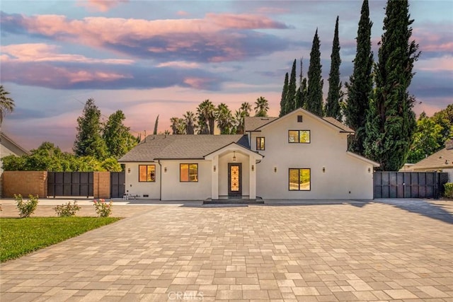 17800 Raymer St, Sherwood Forest, CA 91325 - view of front of property featuring stucco siding, decorative driveway, and a gate