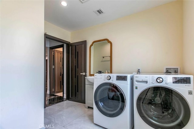17800 Raymer St, Sherwood Forest, CA 91325 - laundry area featuring washer and dryer, cabinet space, light marble finish floors, and recessed lighting