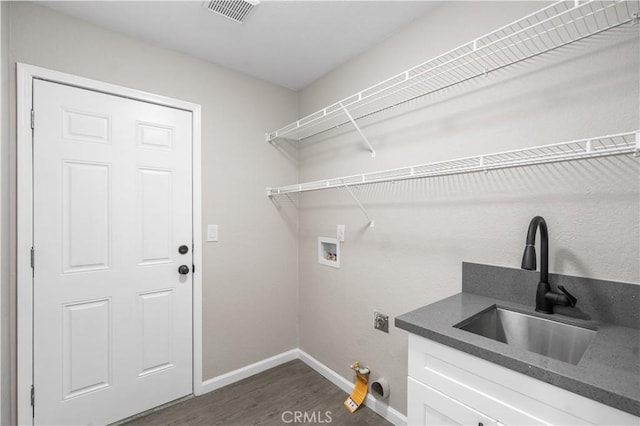 37921 Tackstem St, Palmdale, CA 93552 - laundry area with dark wood finished floors, washer hookup, hookup for a gas dryer, hookup for an electric dryer, and cabinet space