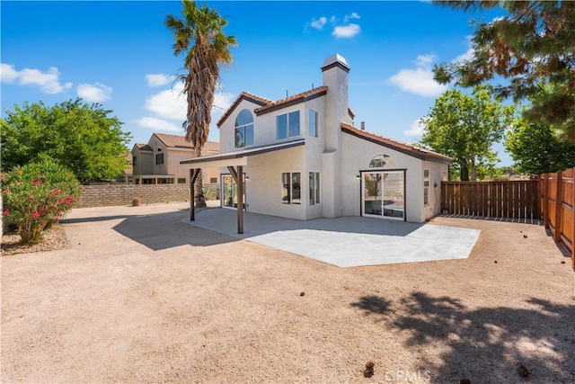 37921 Tackstem St, Palmdale, CA 93552 - rear view of property featuring a chimney, stucco siding, a fenced backyard, and a patio area