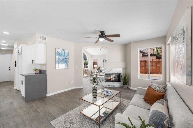 37921 Tackstem St, Palmdale, CA 93552 - living area featuring ceiling fan, wood finished floors, arched walkways, and a premium fireplace