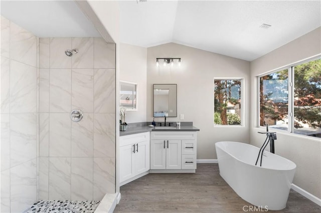 37921 Tackstem St, Palmdale, CA 93552 - full bath with tiled shower, vanity, a freestanding tub, wood finished floors, and vaulted ceiling