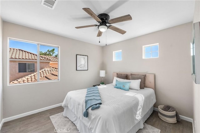 37921 Tackstem St, Palmdale, CA 93552 - bedroom with multiple windows, wood finished floors, and a ceiling fan