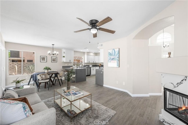 37921 Tackstem St, Palmdale, CA 93552 - living room with a chandelier, a ceiling fan, and wood finished floors