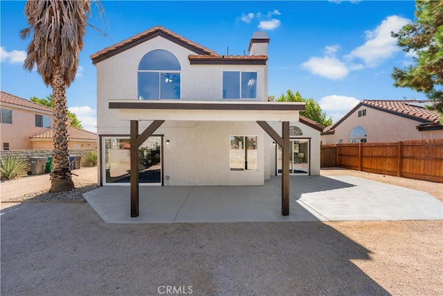 37921 Tackstem St, Palmdale, CA 93552 - rear view of property featuring a chimney, stucco siding, a patio area, and a tile roof