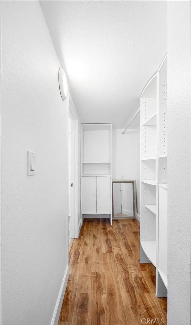 7924 Woodman Ave Unit 20, Panorama City, CA 91402 - walk in closet featuring wood finished floors