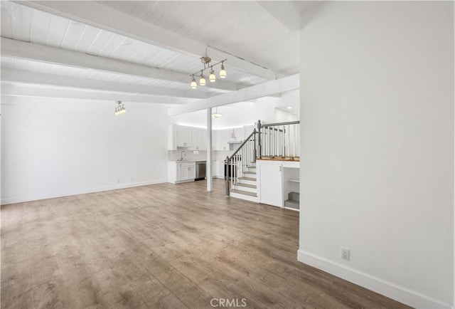 7924 Woodman Ave Unit 20, Panorama City, CA 91402 - unfurnished living room with beamed ceiling, stairway, light wood-style floors, and a chandelier