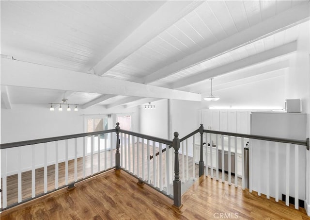 7924 Woodman Ave Unit 20, Panorama City, CA 91402 - corridor featuring an upstairs landing, wood finished floors, and beam ceiling