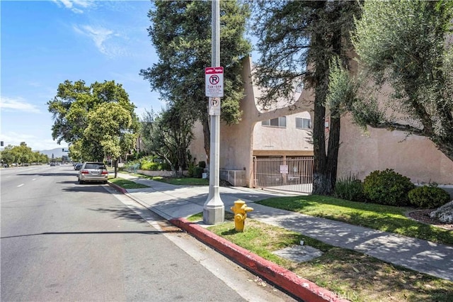 7924 Woodman Ave Unit 20, Panorama City, CA 91402 - view of asphalt street featuring sidewalks, traffic signs, and curbs