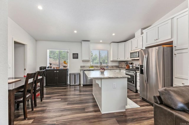 2605 Kauana Loa Dr, Escondido, CA 92029 - kitchen with stainless steel appliances, dark wood finished floors, a center island, white cabinets, and recessed lighting