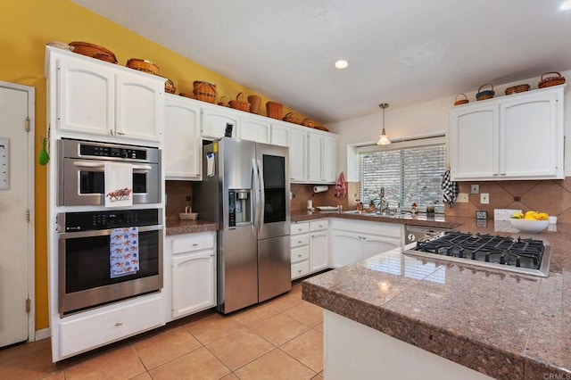 2605 Kauana Loa Dr, Escondido, CA 92029 - kitchen with stainless steel appliances, tile counters, white cabinets, and recessed lighting
