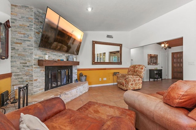 2605 Kauana Loa Dr, Escondido, CA 92029 - tiled living room featuring a stone fireplace, lofted ceiling, and a chandelier