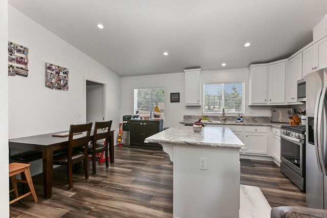 2605 Kauana Loa Dr, Escondido, CA 92029 - kitchen featuring stainless steel appliances, dark wood-style flooring, a kitchen island, vaulted ceiling, and white cabinets