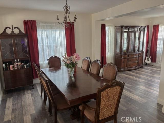 12920 La Costa Ct, Hesperia, CA 92344 - dining room featuring wood finished floors and a chandelier