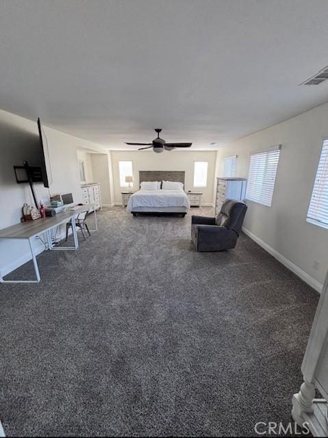 12920 La Costa Ct, Hesperia, CA 92344 - bedroom with multiple windows, carpet flooring, a ceiling fan, and a desk