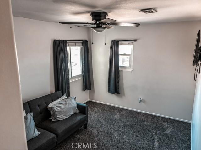 12920 La Costa Ct, Hesperia, CA 92344 - sitting room with carpet and a ceiling fan