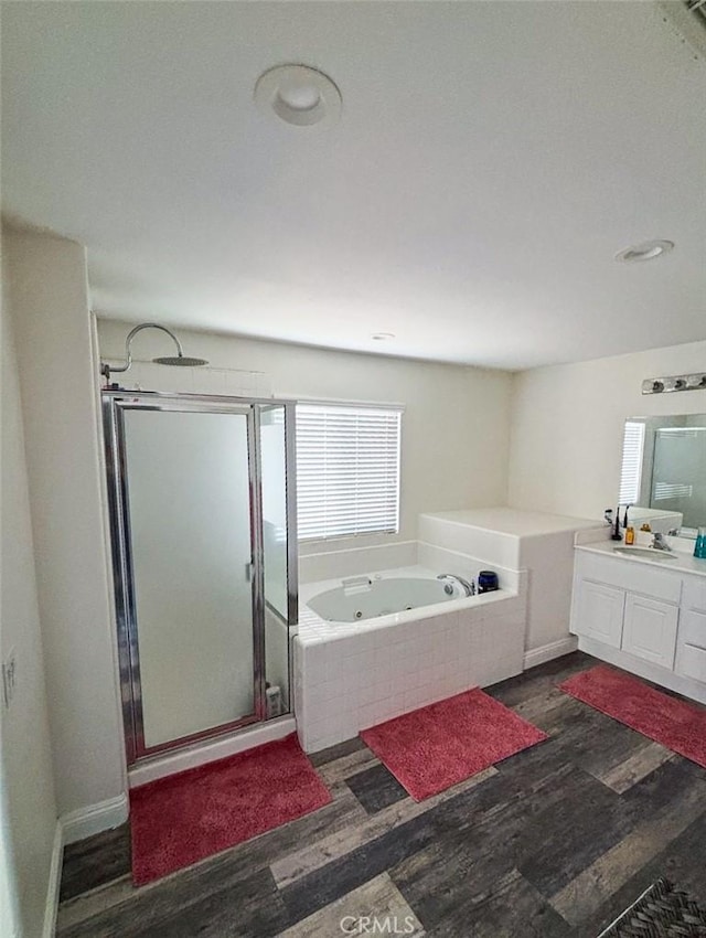 12920 La Costa Ct, Hesperia, CA 92344 - full bathroom with wood finished floors, a stall shower, a jetted tub, and vanity