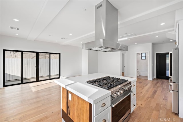214 W Mariposa Unit B, San Clemente, CA 92672 - kitchen featuring stainless steel appliances, island range hood, light wood finished floors, a center island, and light countertops