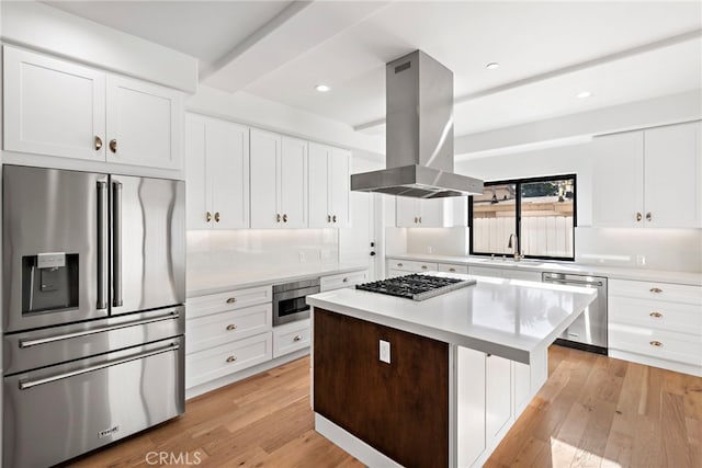 214 W Mariposa Unit B, San Clemente, CA 92672 - kitchen featuring stainless steel appliances, island exhaust hood, a center island, light wood finished floors, and recessed lighting