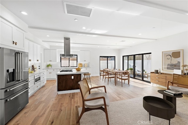 214 W Mariposa Unit B, San Clemente, CA 92672 - kitchen featuring appliances with stainless steel finishes, island exhaust hood, light wood-type flooring, light countertops, and recessed lighting