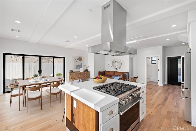 214 W Mariposa Unit B, San Clemente, CA 92672 - kitchen with appliances with stainless steel finishes, island range hood, healthy amount of natural light, light wood finished floors, and beamed ceiling